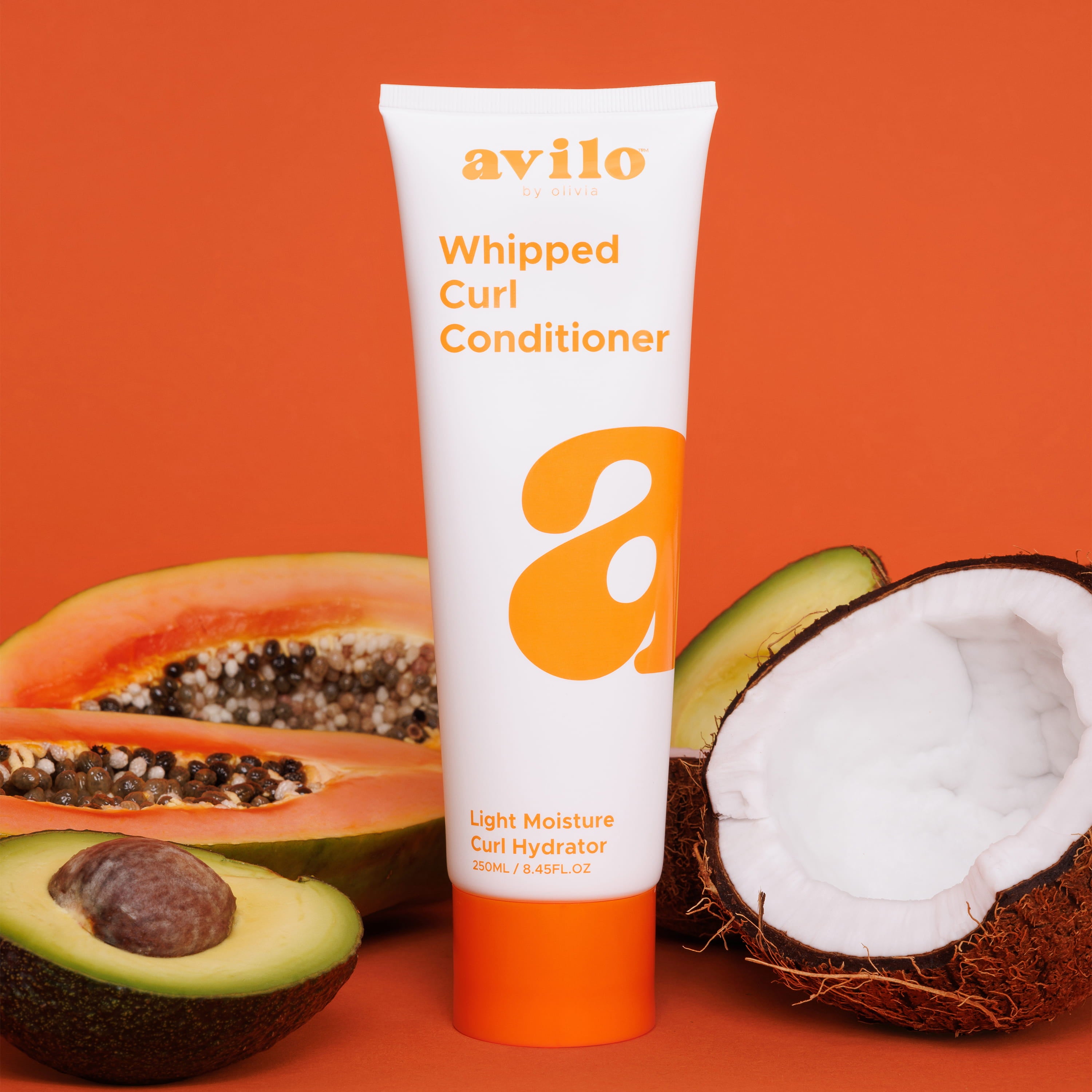 vilo whipped curl conditioner tube with papaya, avocado, and coconut on an orange background