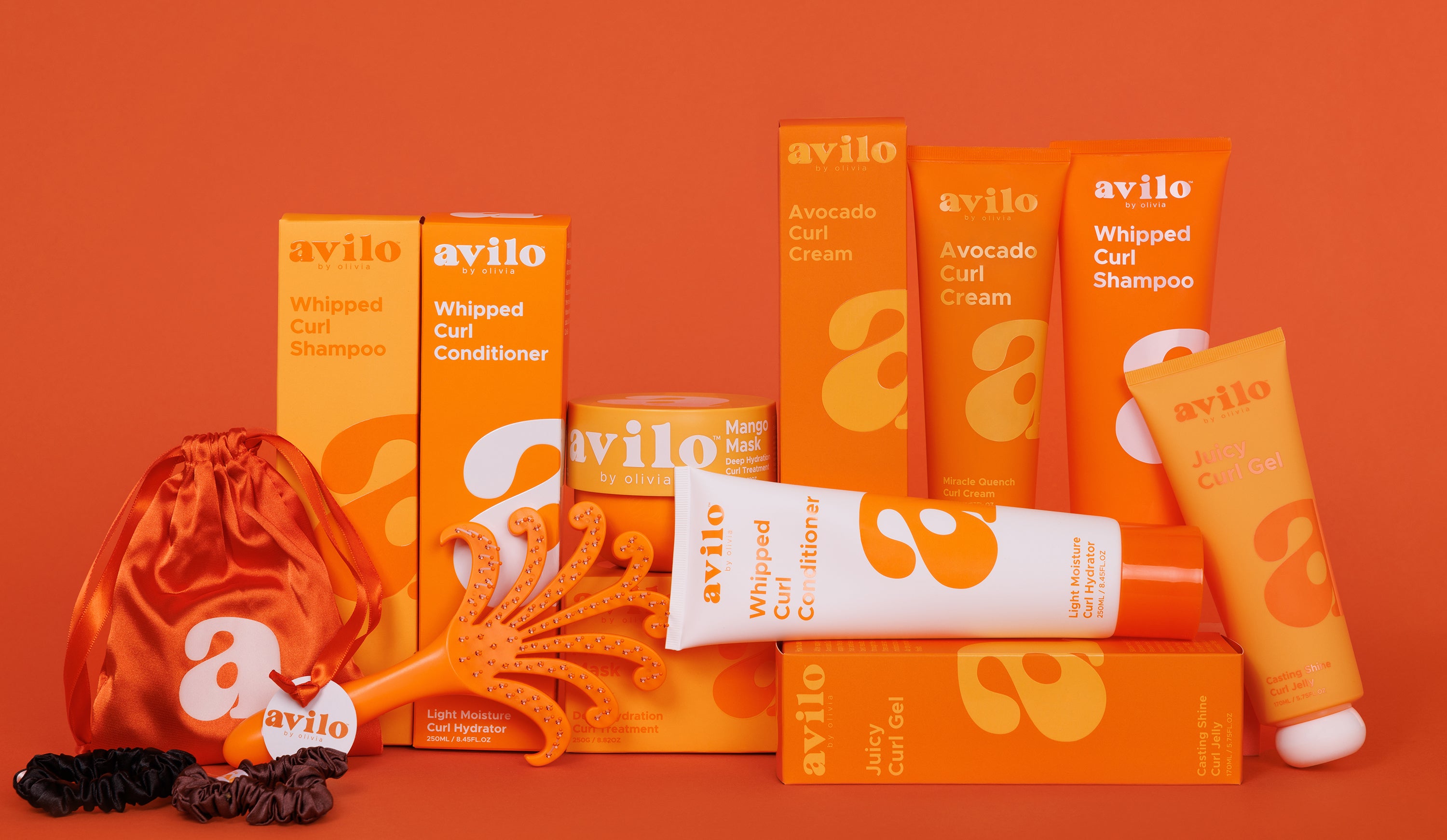 Avilo hair care products on an orange background