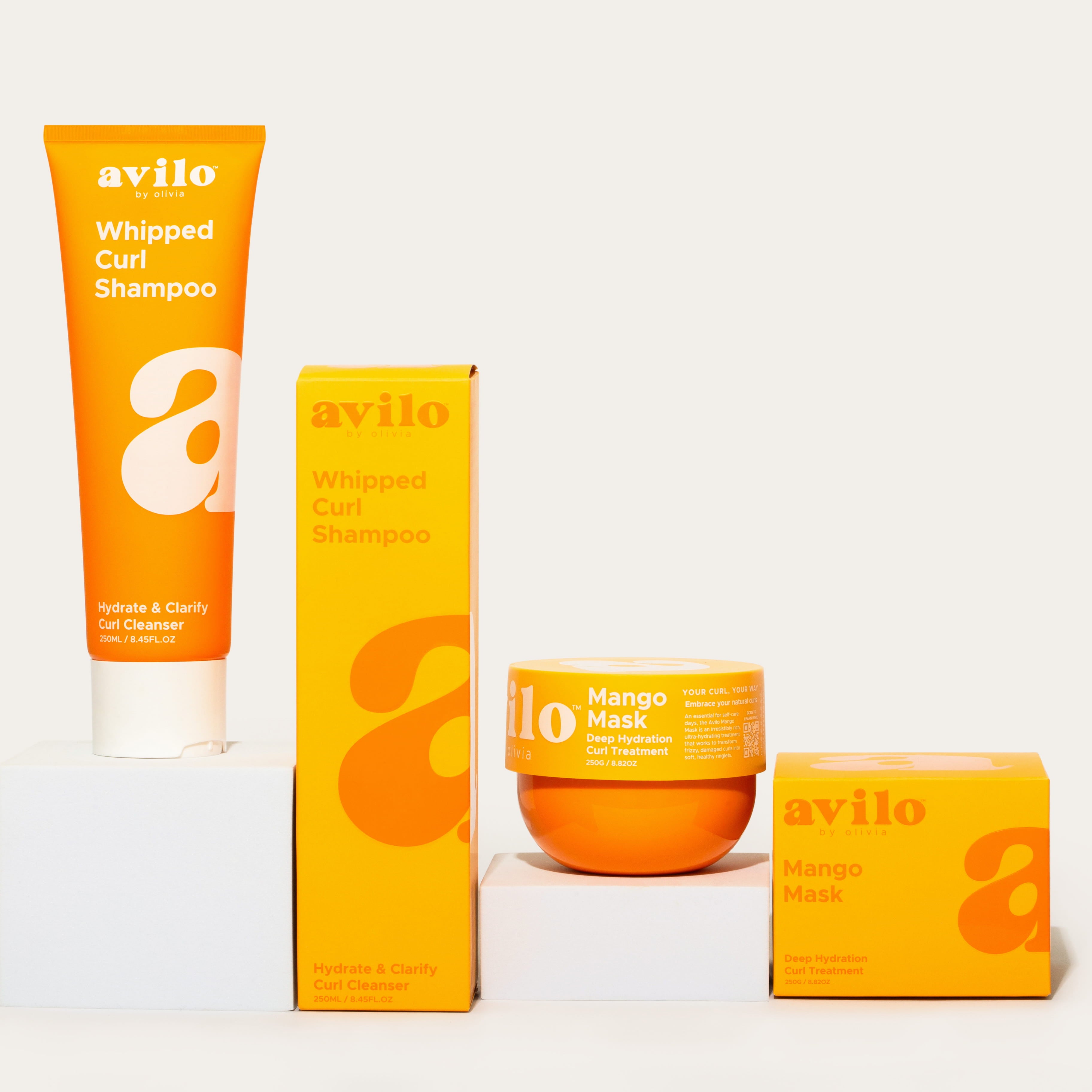 Avilo whipped curl shampoo and mango mask products on a white background