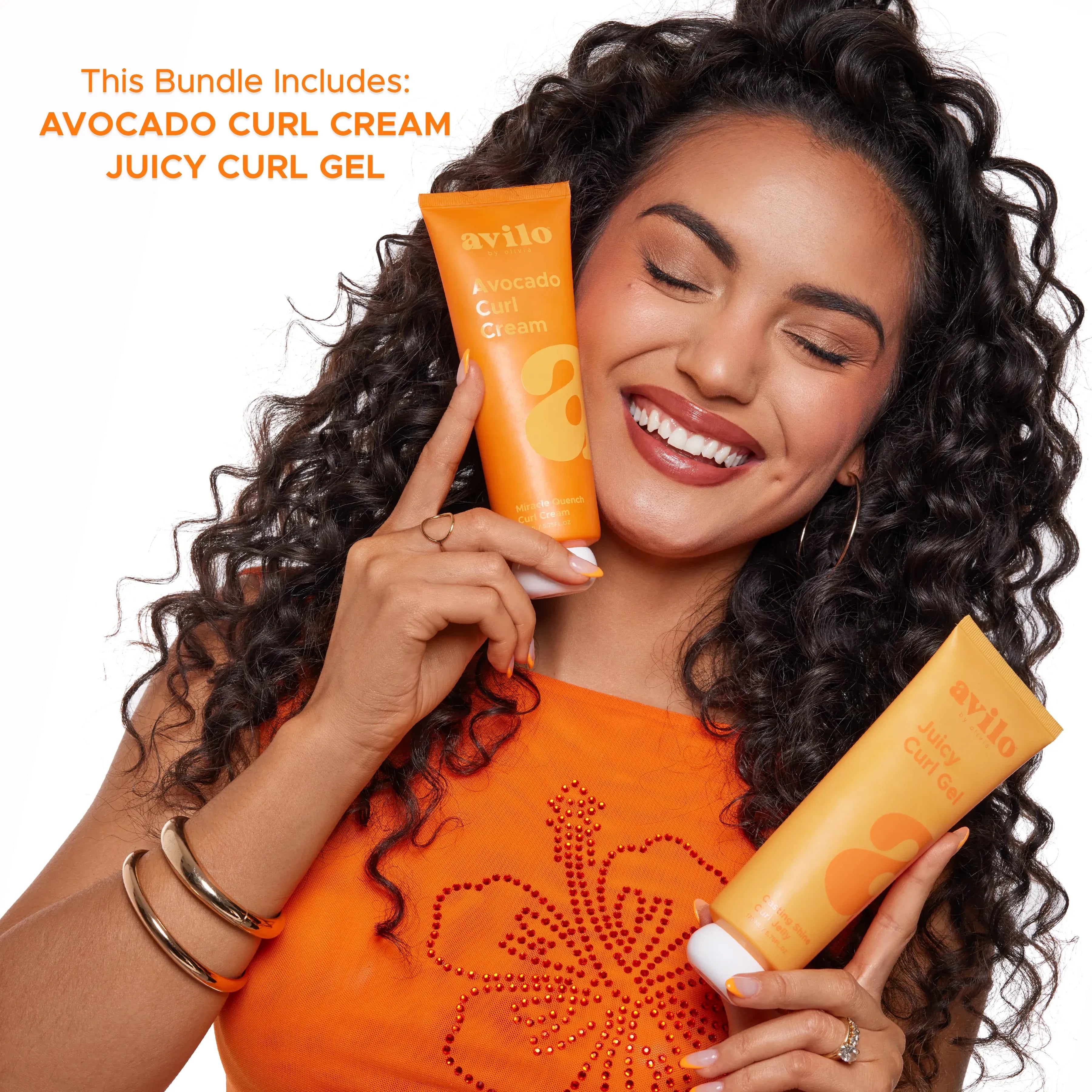 Woman holding Avvolu Avocado Curl Cream and Juicy Curl Gel with product packaging in the foreground.