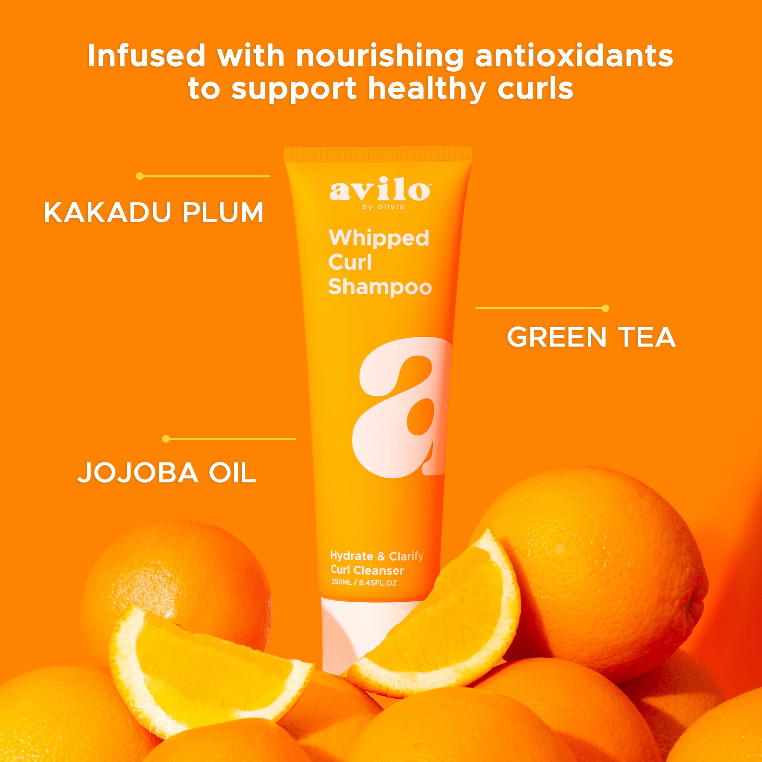 Avilo whipped curl shampoo with oranges on an orange background

