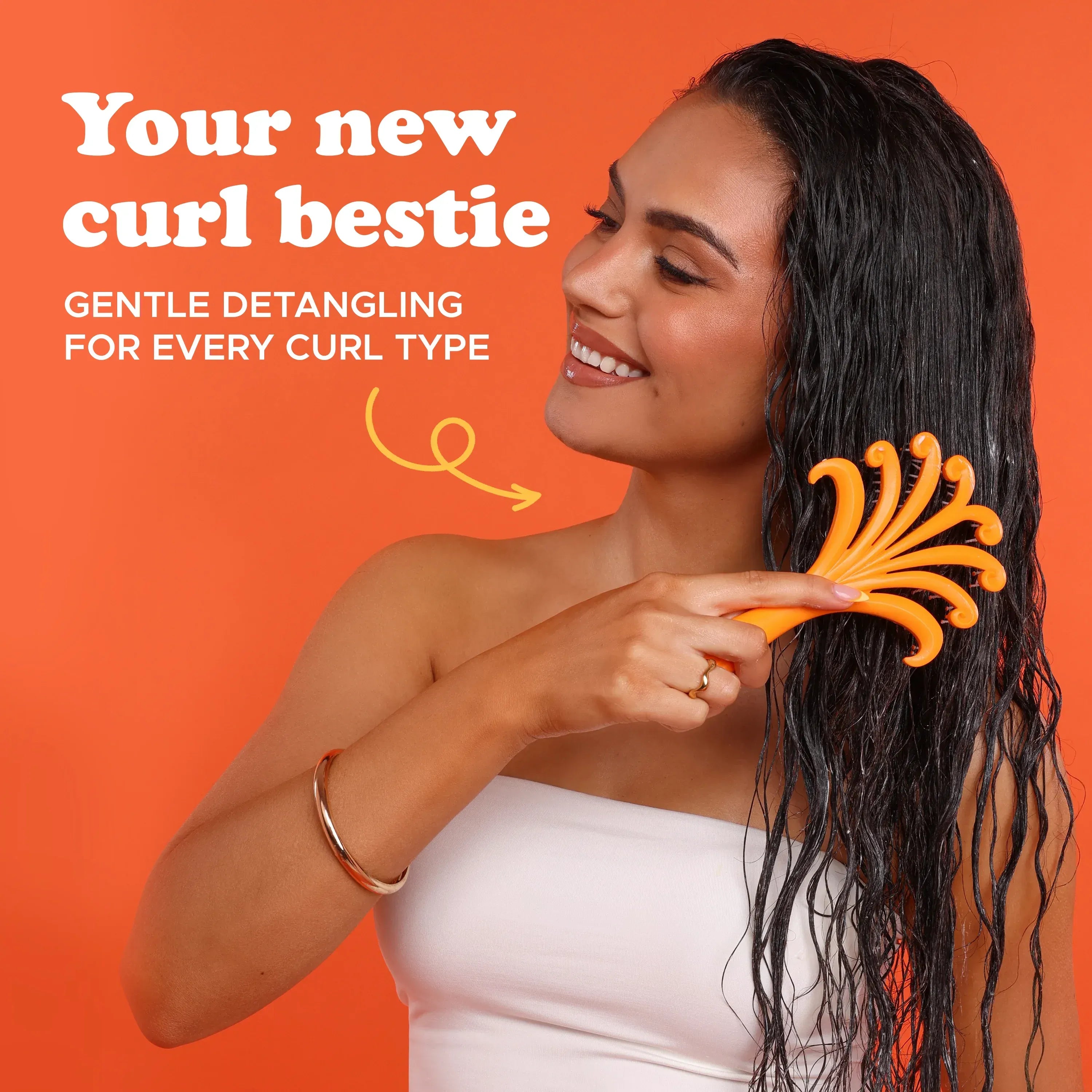 Woman using a yellow detangling comb on wet hair with an orange background and text about gentle detangling.