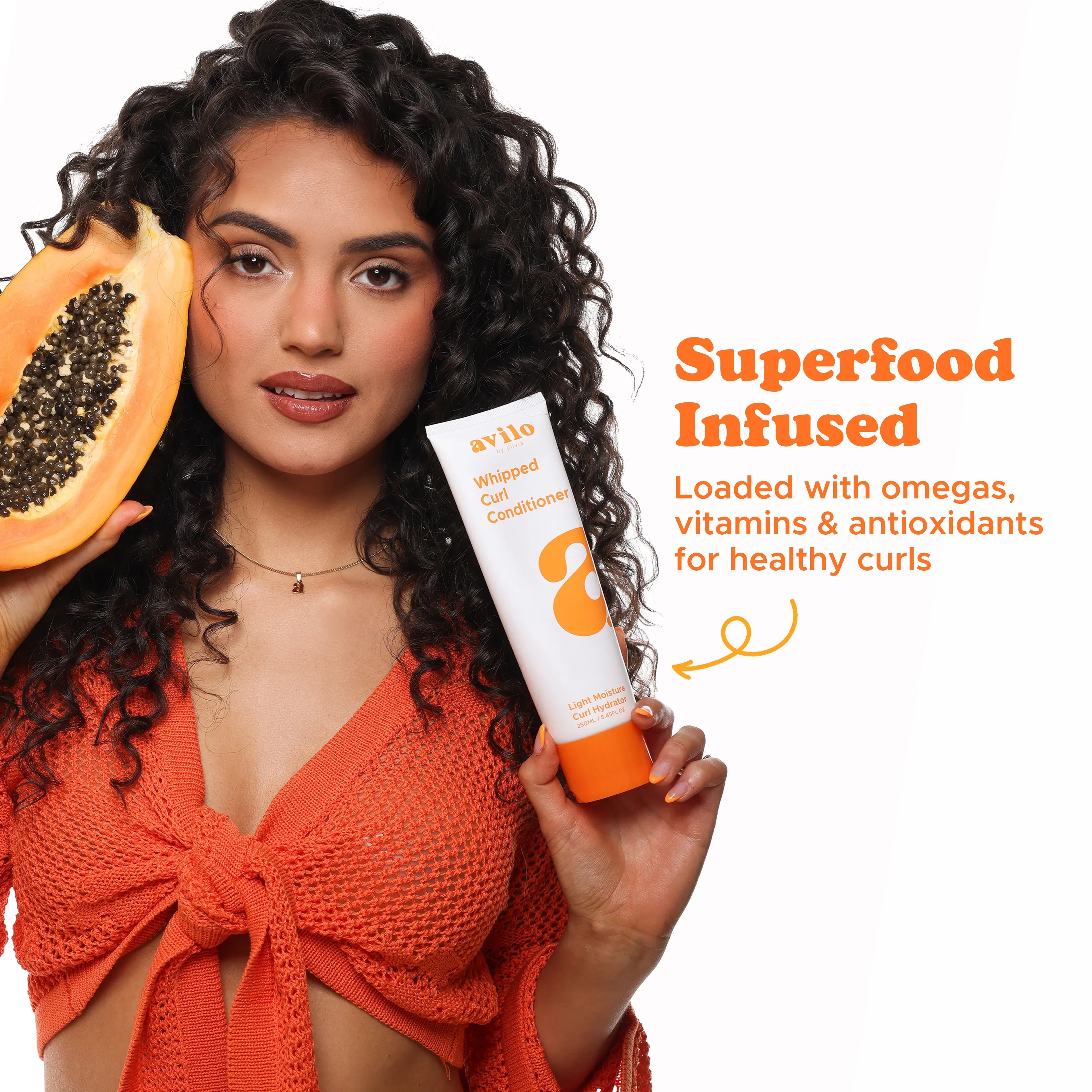 Woman holding a tube of hair conditioner and a papaya, with text about superfood-infused product.
